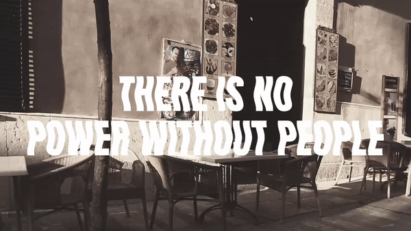 A loop of clips depicting an empty cafe, an empty street, an empty house, an walkway and an empty highway with the text. “There is no power without people”